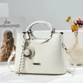Detail of white lychee pattern leather handbag with metal handles and a mini hat charm - 23x11x18cm / Off White