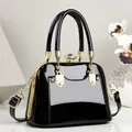 Elegant black patent leather handbag with gold hardware and crystal clasp. - 21*11*15 / Black