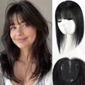 Close-up detail of human hair topper with Swiss net base and natural front bangs - Black