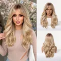 Detailed macro view showing the texture of long wavy blonde balayage wig with curtain bangs - 20 inch / Black Tea Ombre Gold