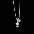 Detailed close-up of a silver necklace with a white enamel flower and small heart charm - White Daisy Clavicle Necklace