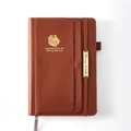 Brown faux leather 18-month 2024-2025 planner notebook with gold lion logo detail - Brown