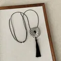 Detail of a Neo-Chinese style shell necklace with a black gemstone and long tassel. - Silver Drawstring Necklace