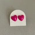 Close-up of vibrant magenta drip oil heart stud earrings on a textured display card - Heart Shape Style / Rose Red