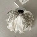 Detailed view of an olive green floral bow hair claw clip with elegant pearl ruffles - Green Floral Bow Hair Claw