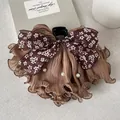 Close-up of floral bow hair claw clip with brown ruffled fabric and white pearl accents. - Coffee Floral Bow Hair Claw