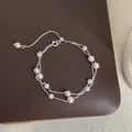 Macro view of a double-layered silver bracelet with pink pearls and crystal beads - Starry Sky Double Layer (Style 6)