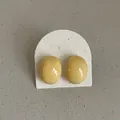 Macro detail of yellow geometric bean stud earrings with a glossy oil-dripped finish - Geometric Bean Style (Style 14) / Bright yellow
