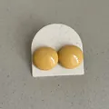 Close-up of vibrant yellow bean-shaped drip oil stud earrings on a display card - Geometric Bean Style (Style 16) / Bright yellow