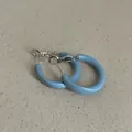 Close-up of light blue oil-dripped geometric hoop earrings with silver-tone findings - Geometric Bean Hoop Style / Light Blue