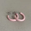 Close-up of pink enamel hoop earrings with a smooth, glossy dopamine-style finish - Geometric Round Style / Pink