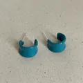 Close-up of teal drip oil C-shaped geometric hoop earrings on a textured background. - Geometric C-Shape Style (Style 33) / Cyan Green