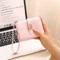 Compact pink wallet for women with elegant cracked leather texture and wrist strap. - Pink