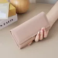 Elegant mauve pink long wallet for women featuring minimalist silver metal trim detail - Pink
