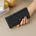 Elegant women's black leather long wallet with large capacity and stylish buckle clasp. - Black