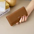 Elegant brown ladies long leather wallet featuring clasp closure and large capacity - Brown