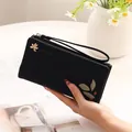 Elegant black PU leather long wallet for women with floral print and wrist strap. - Black