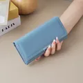 Elegant light blue long wallet for women featuring a minimalist design and soft texture - Blue