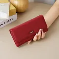 Elegant red pebbled leather long wallet for women featuring a stylish metal buckle design - Red