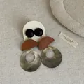 Macro detail of retro shell and wood patchwork drop earrings on textured linen background - Style 6 Earrings
