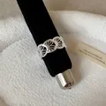 Detailed macro view of minimalist silver hollow scalloped design ring on black velvet - French Fan-Shaped Hollow Rhinestone Style (Style 32 Ring)