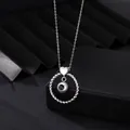 Detailed macro shot of silver heart and twisted circle projection necklace pendant - White Gold
