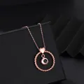 Close-up of rose gold heart and twisted circle projection necklace on jewelry box - Rose Gold
