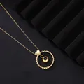 Macro view of the golden projection necklace featuring a twisted ring and heart bail detail. - Gold