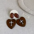 Detail of vintage wooden heart earrings with silver-tone cross and clear gemstone adornment. - Style 2 Snowflake Earring