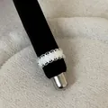 Close-up detail of a French style silver openwork lace ring on a black velvet stand. - Wavy Lace Style (Style 1 Ring)