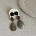 Detail of vintage drop earrings featuring wooden beads and teardrop shell pendants. - Style 12 Earrings