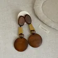 Close-up of vintage wooden geometric earrings with natural textures and mustard yellow accent - Style 6 Earrings