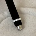 Close-up detail of a silver French lace hollow metal ring on a black display stand - Floral Lace Pave Rhinestone Style (Style 6 Ring)
