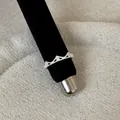 Macro view of a silver crown-shaped ring featuring elegant lace hollow patterns and stones - Crown Milgrain Edge Style (Style 7 Ring)