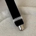 Detailed macro view of an intricate silver lace openwork metal ring on display stand - Floral Hollow Style (Style 11 Ring)