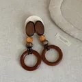 Close-up view of retro wooden geometric drop earrings featuring natural splicing textures. - Style 11 Earrings