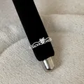 Macro detail of a silver French lace hollow ring featuring a sparkling heart-shaped stone - Heart Gemstone Hollow Style (Style 13 Ring)