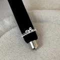 Detailed macro view of a silver French style lace hollow bow ring on black velvet stand - Bowknot Hollow Style (Style 15 Ring)