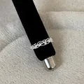 Detailed macro view of an intricate silver lace hollow filigree ring on a black stand - Lace Hollow Rhinestone Style (Style 16 Ring)