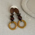 Detailed macro view of vintage wooden earrings featuring unique multi-shape bead patchwork design - Style 14 Earrings