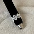 Detailed view of a silver French-style lace openwork metal ring on a black velvet display rod - Lace Hollow Pattern Style (Style 22 Ring) / Silver