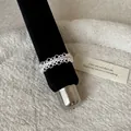 Close-up detail of a silver French-style lace openwork ring on a black display stand. - Geometric Hollow Lace Style (Style 10 Ring)