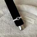 Macro view of vintage style silver lace ring featuring a mysterious round cat's eye gemstone - Cat's Eye Floral Hollow Style (Style 14 Ring)