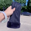 Close-up of women's navy blue suede winter gloves with plush faux fur cuffs - Single Vertical Line / Black