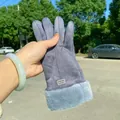 Detailed view of women's warm grey suede winter gloves featuring soft plush fur cuffs - Single Vertical Line / Gray