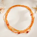 Vue détaillée de la chaîne de taille en perles orange avec des pierres irrégulières. - Orange (07527)
