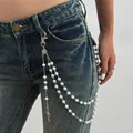 Macro detail view of a hip-hop style pearl and cross pendant pant chain on denim jeans. - Silver Double Layer Pearl Style (1964) / Silver & White