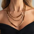 Multi-layered necklace with vintage gold metallic tubes and brown wooden beads. - Necklace (7900K2)