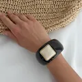 Vintage black resin chunky bangle bracelet with cream square detail on model wrist - Glossy Black Square Decor (3193) / Dark Brown