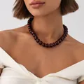 Bohemian dark red marbled resin bead necklace with gold spacers worn by model. - Black and Red Necklace (7957)